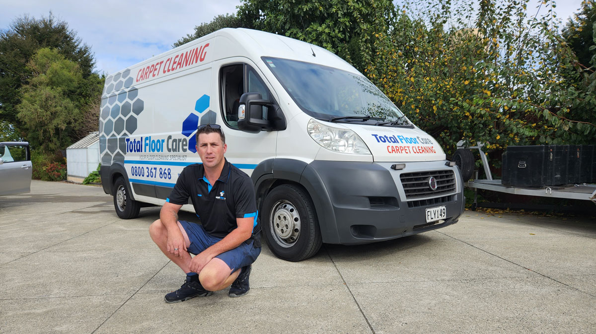Jamie — owner of Total Floor Care, with the truckmount van in Christchurch